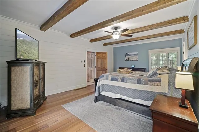 a spacious bedroom with a bed and a window