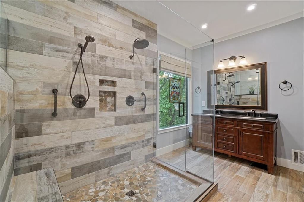 188 Tea Berry Lane Jasper, GA 30143 - Photo 28 of 68 a bathroom with a granite countertop sink a mirror and shower