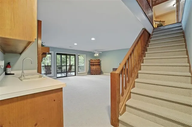 a view of a livingroom with furniture and stairs