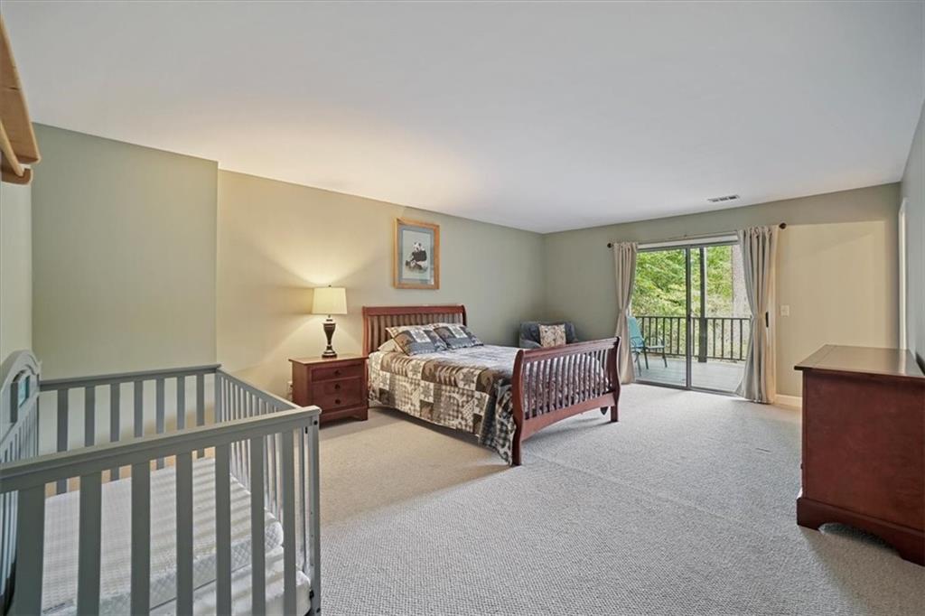 188 Tea Berry Lane Jasper, GA 30143 - Photo 32 of 68 a spacious bedroom with a bed and a window