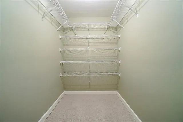 a bedroom with a bed and a large mirror