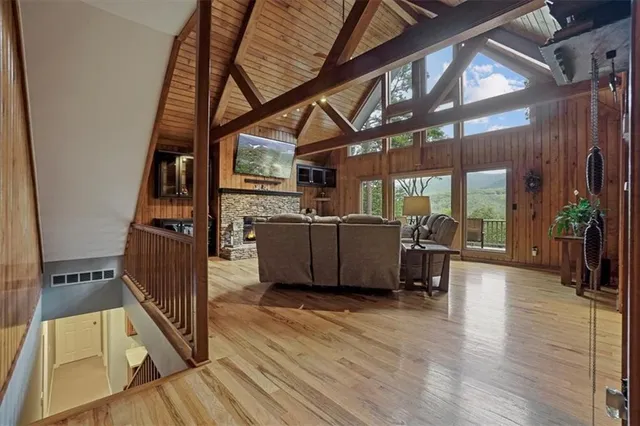 a living room with furniture a wooden floor and next to a window