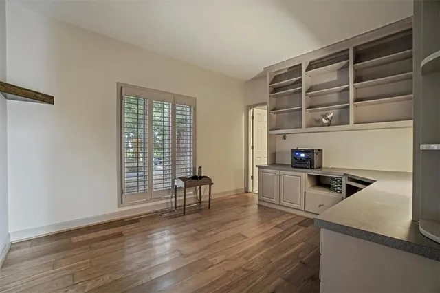a kitchen with granite countertop white cabinets and white appliances