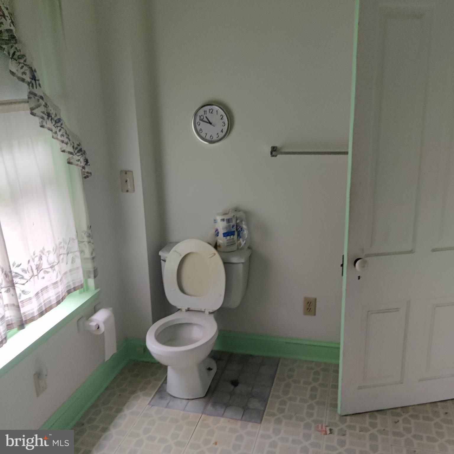 209 Sharpless Street West Chester, PA 19382 - Photo 7 of 12 a white toilet sitting next to a bathroom sink and a window