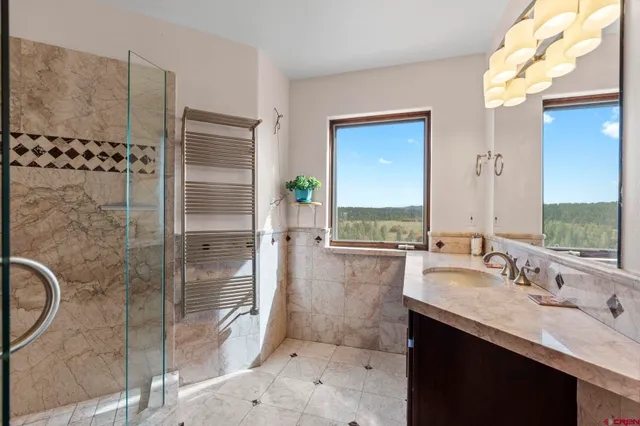 a bathroom with a double vanity sink toilet and shower