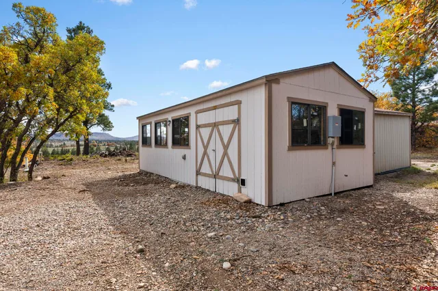 a view of a white house with a yard