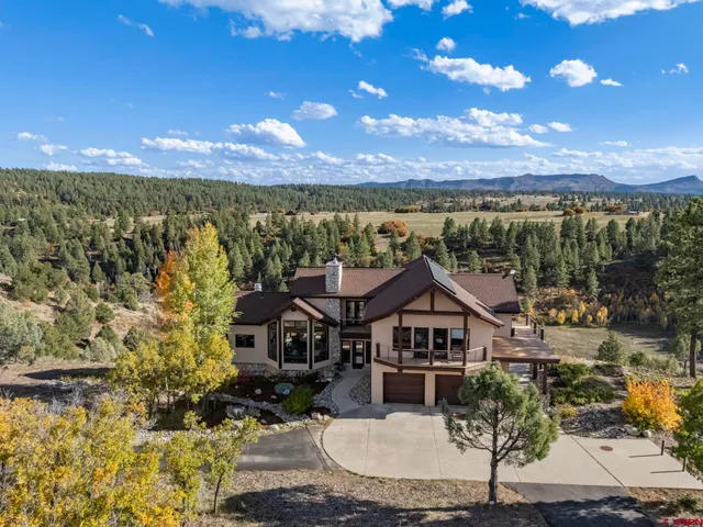 a view of a house with a yard and lake view