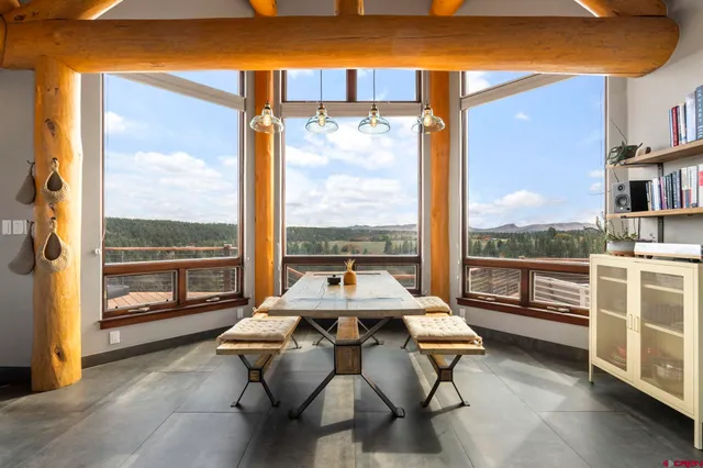 a living room with furniture and a floor to ceiling window