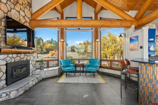 a view of a patio with a table and chairs and a barbeque