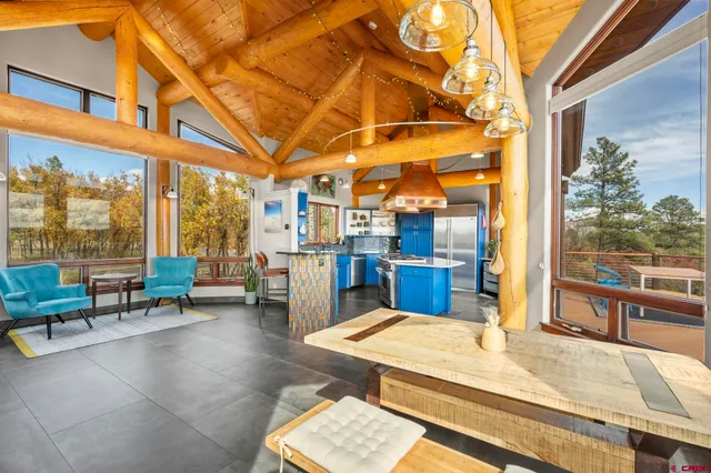 a room with lots of table chair and view of living room