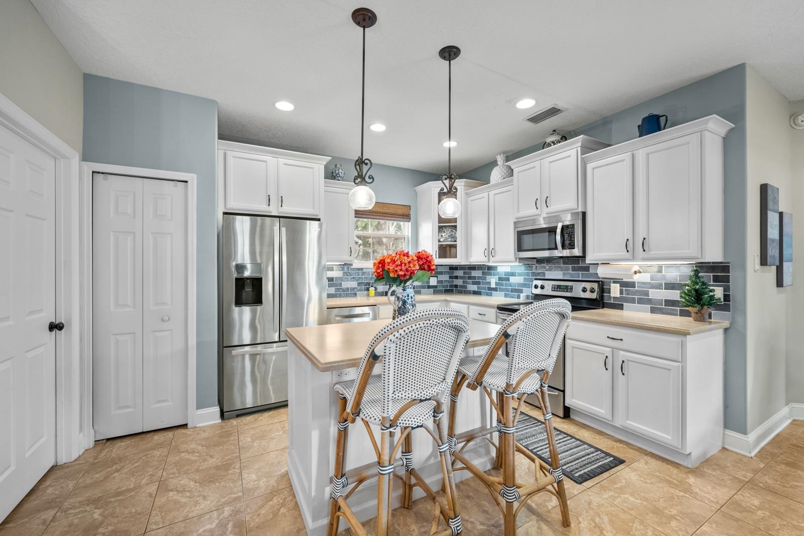 120 Menendez Road, Unit A St. Augustine, FL 32080 - Photo 12 of 50 a kitchen with stainless steel appliances kitchen island granite countertop a refrigerator and white cabinets