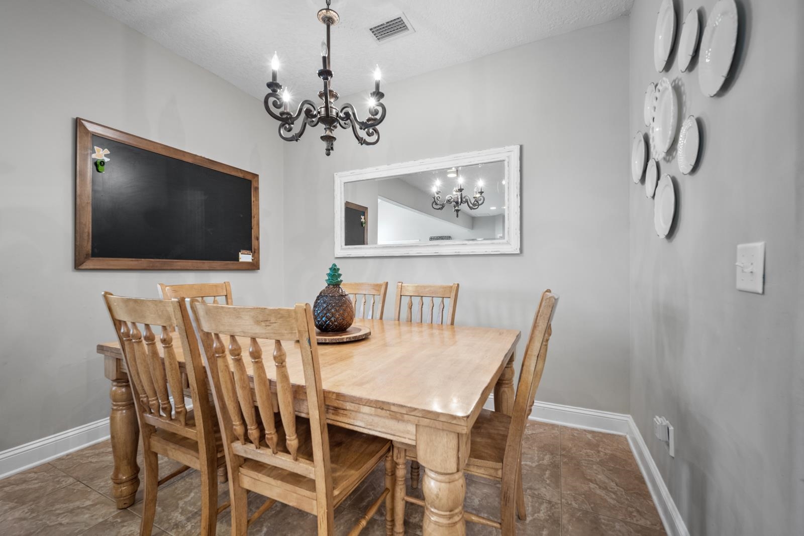 120 Menendez Road, Unit A St. Augustine, FL 32080 - Photo 15 of 50 a view of a dining room with furniture wooden floor and a chandelier