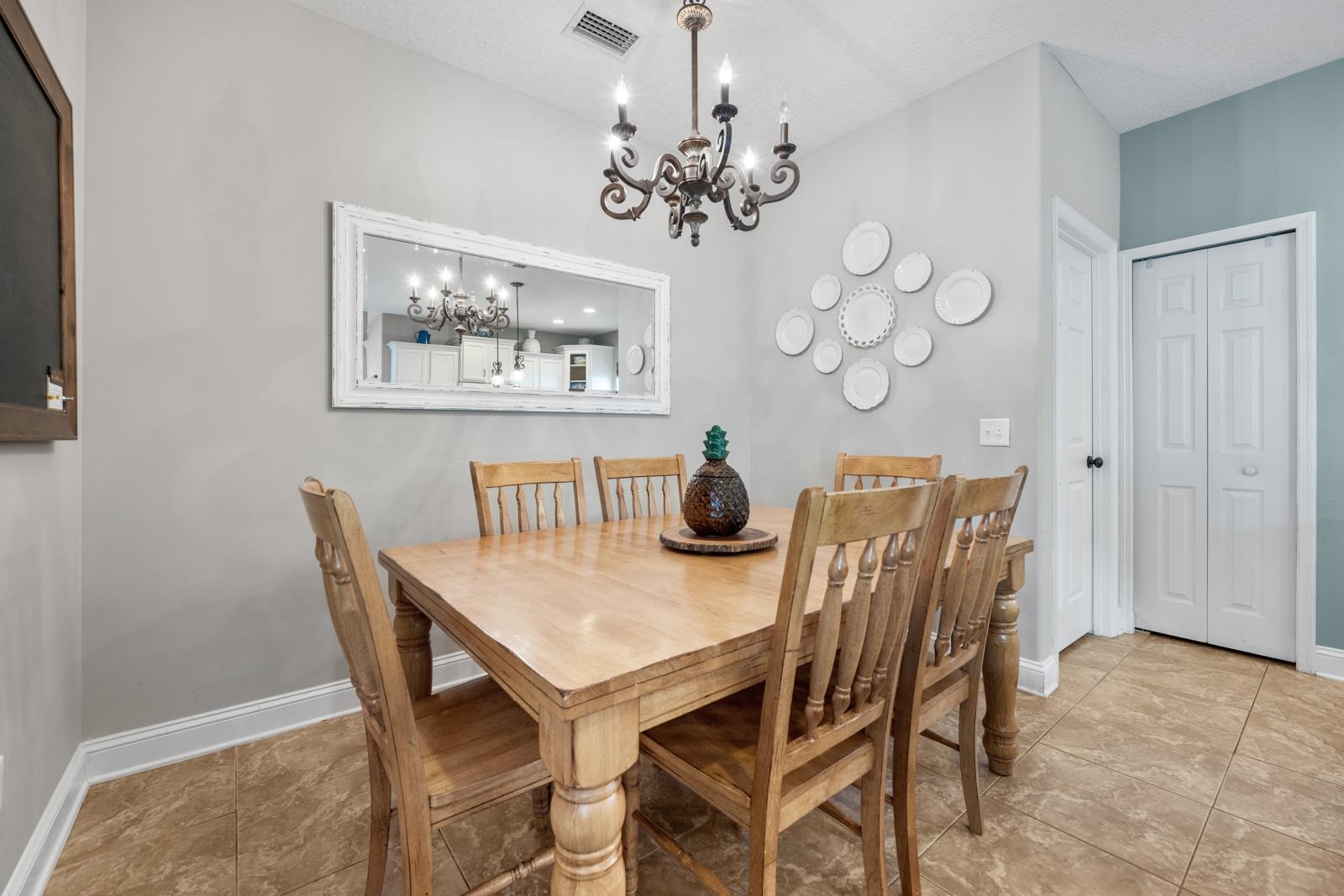 120 Menendez Road, Unit A St. Augustine, FL 32080 - Photo 16 of 50 a view of a dining room with furniture and chandelier