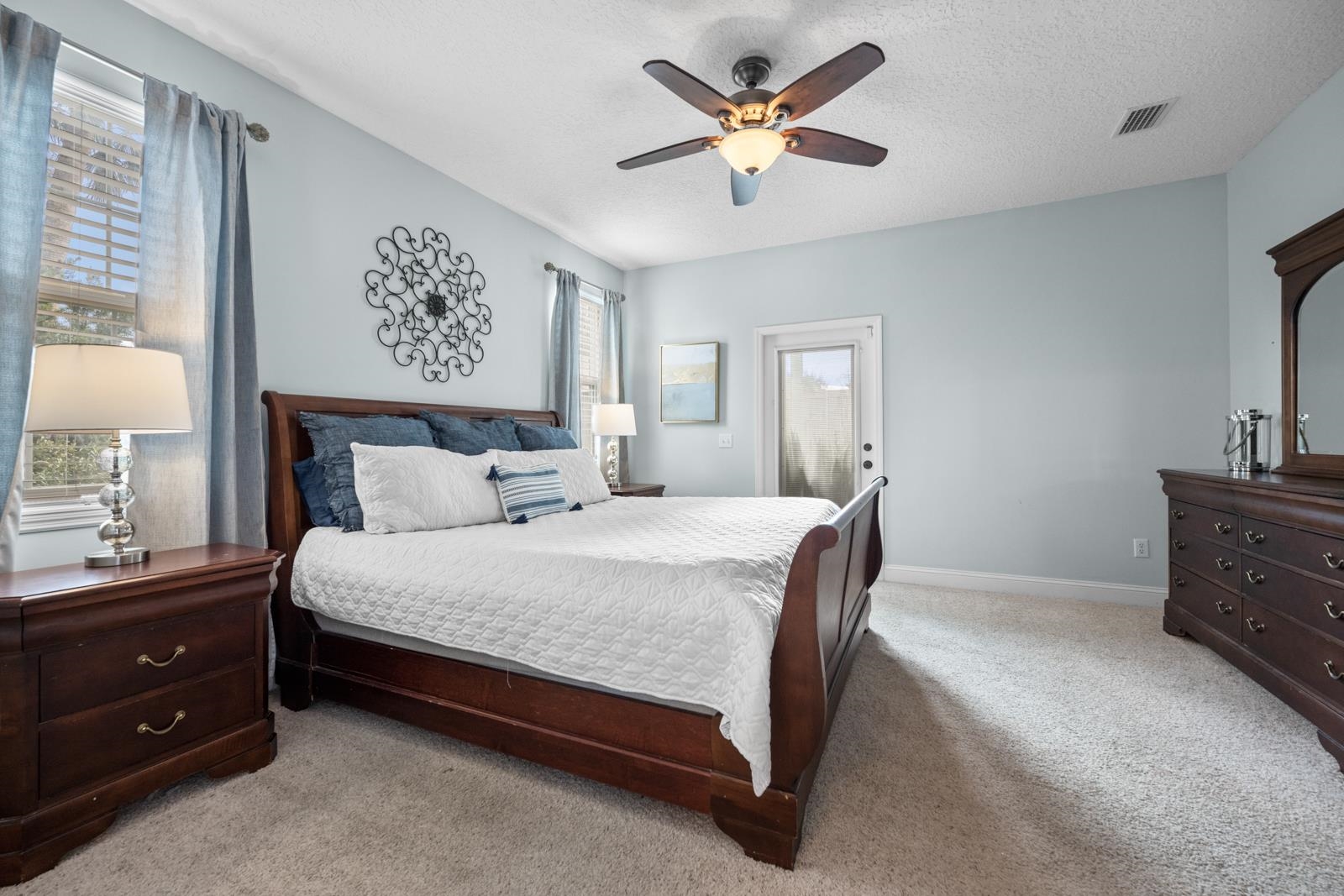 120 Menendez Road, Unit A St. Augustine, FL 32080 - Photo 17 of 50 a bedroom with a bed and a chandelier