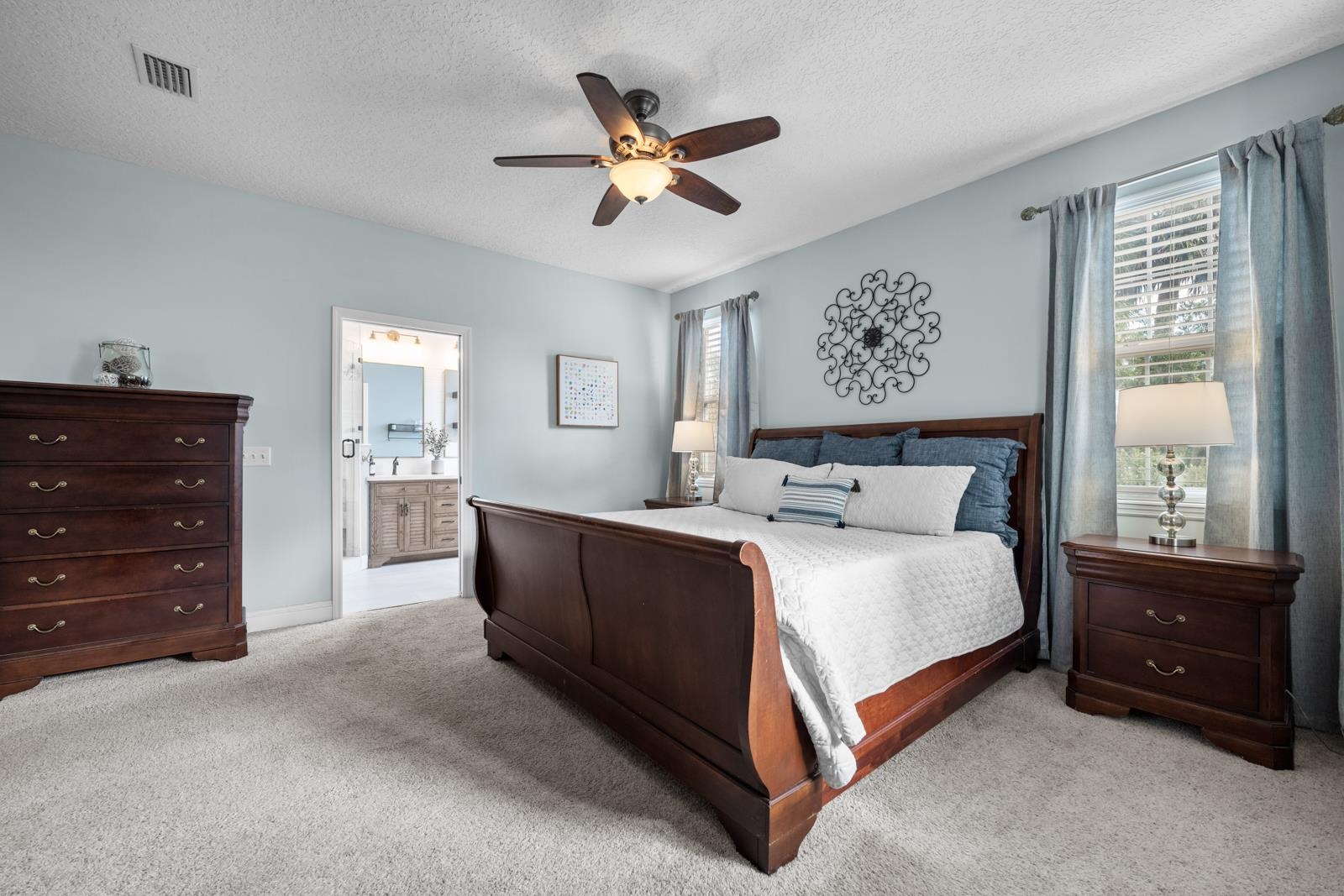 120 Menendez Road, Unit A St. Augustine, FL 32080 - Photo 18 of 50 a bed room with a bed and a ceiling fan