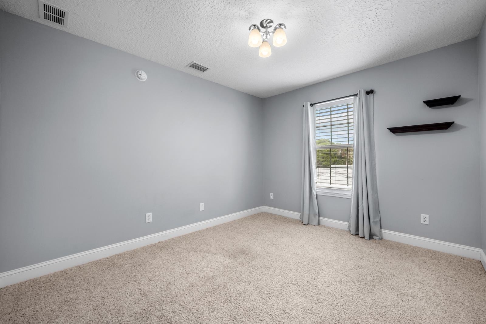 120 Menendez Road, Unit A St. Augustine, FL 32080 - Photo 26 of 50 an empty room with a empty space and a ceiling fan