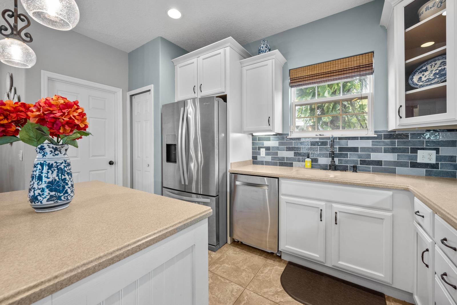 120 Menendez Road, Unit A St. Augustine, FL 32080 - Photo 10 of 50 a kitchen with white cabinets and chandelier