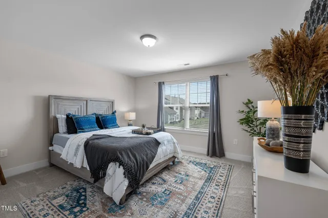 a bedroom with a bed and a potted plant