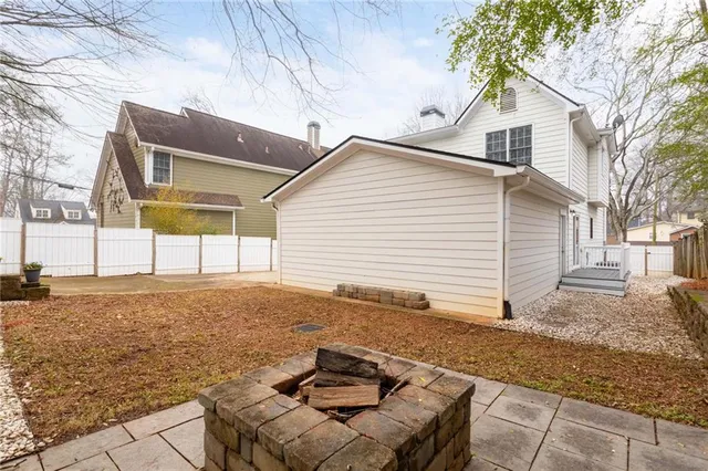 a backyard of a house with yard and outdoor seating