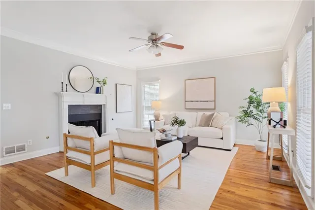 a living room with furniture a fireplace and a chandelier