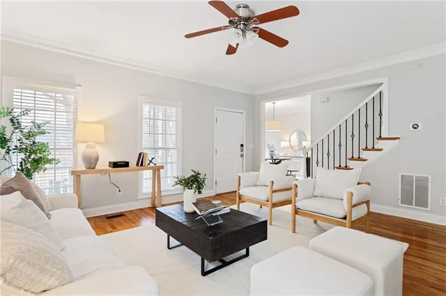a living room with furniture and a wooden floor