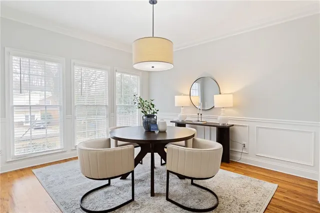 a dining room with furniture and a window