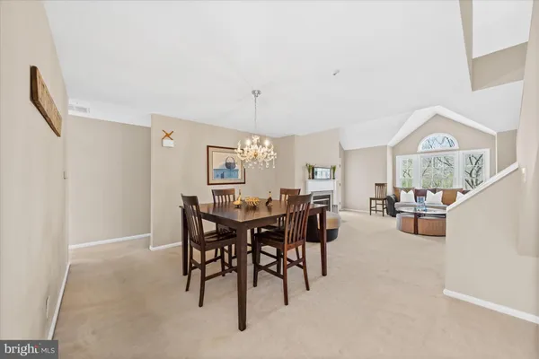 a view of a dining room and livingroom with furniture window and wooden floor