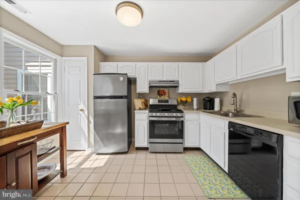 a kitchen with a refrigerator sink and stove