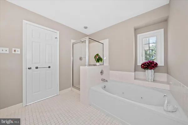 a white bath tub sitting next to a white walls