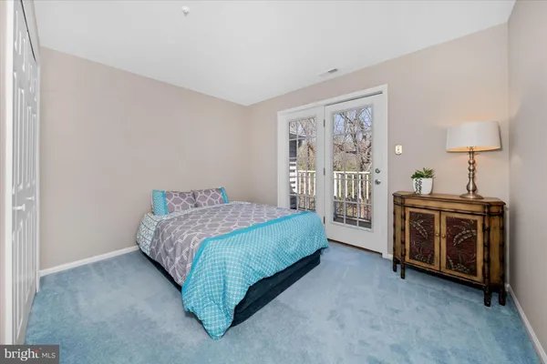 a spacious bedroom with a bed and a cabinets