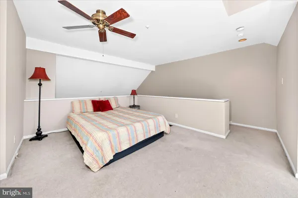 a bedroom with a bed and a ceiling fan