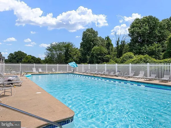 a view of a backyard with swimming pool