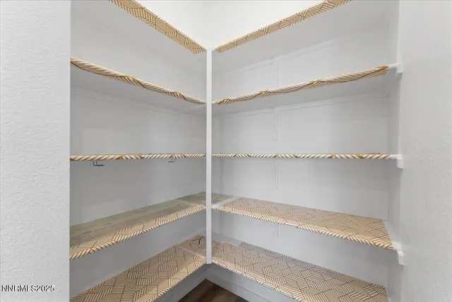 a view of walk in closet with empty racks