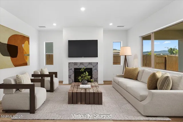 a living room with furniture a flat screen tv and a fireplace