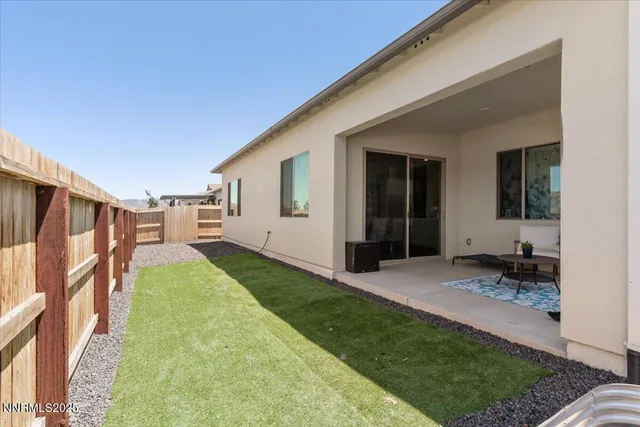 a view of backyard with seating area
