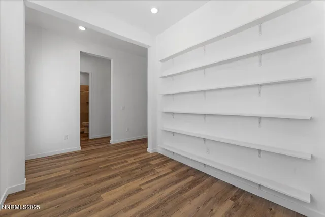 a view of walk in closet with empty racks