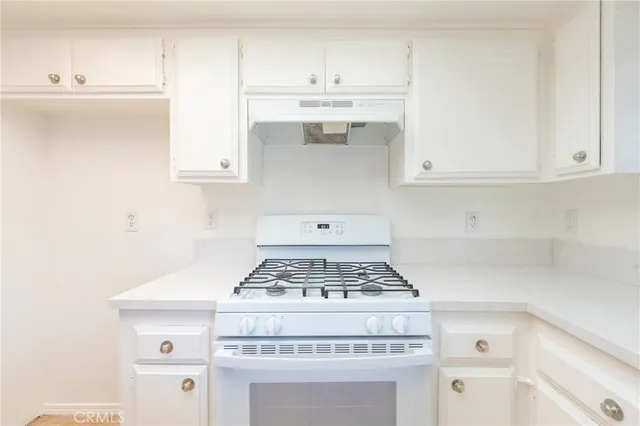 a stove top oven sitting inside of a kitchen