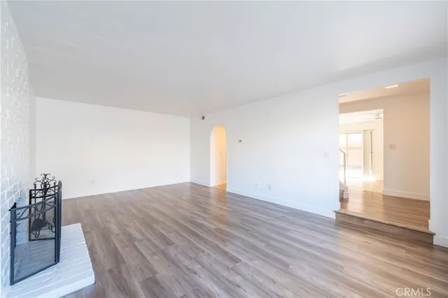 a view of an empty room and wooden floor