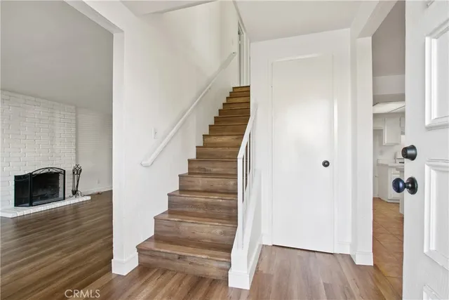 a view of a hallway with wooden floor and staircase