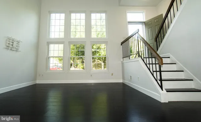 a view of an entryway with wooden floor and windows