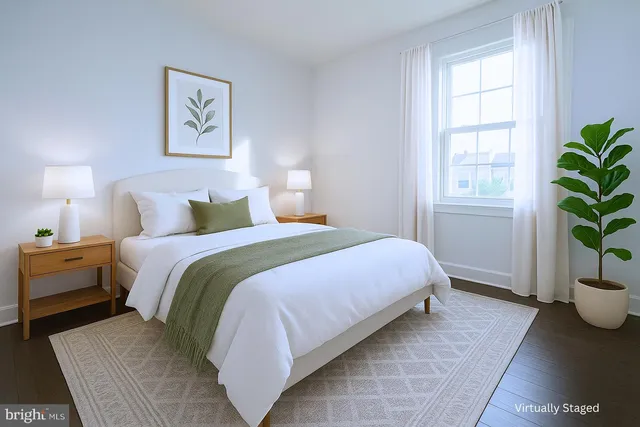 a bedroom with a bed and a potted plant