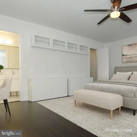 a living room with furniture and a ceiling fan