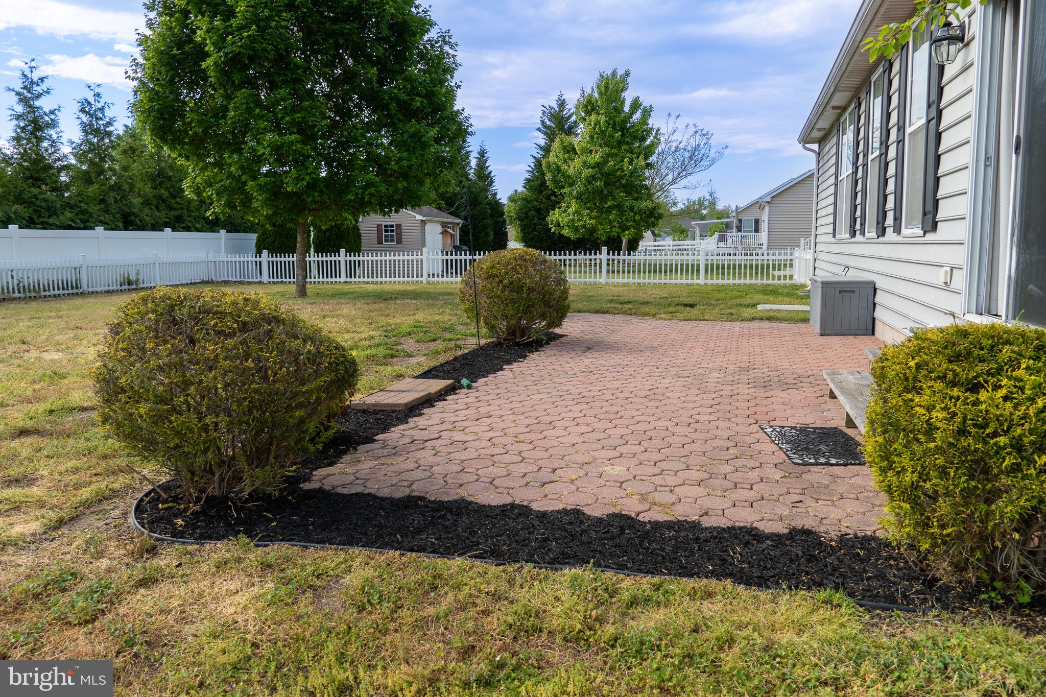27 Sun Ridge Drive Felton, DE 19943 - Photo 4 of 41 Charming patio with lush greenery.