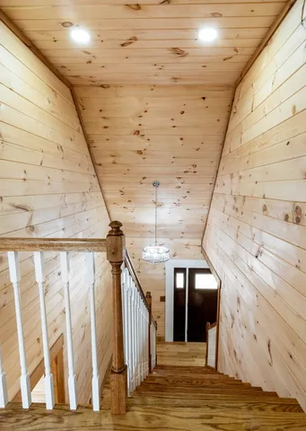a view of a hallway with wooden floor and entryway