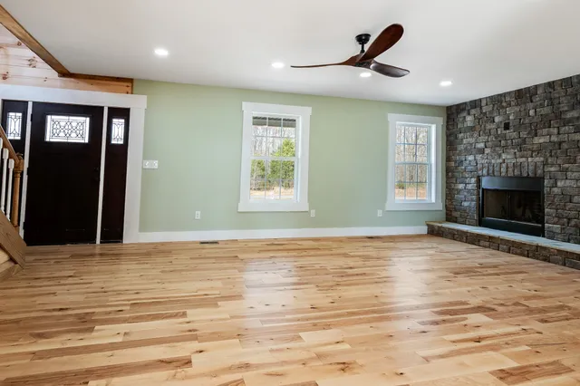 a living room with a fireplace and a wooden floor