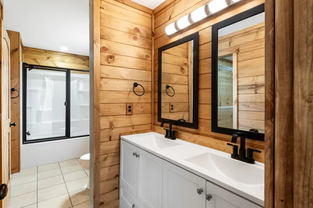 a bathroom with a glass shower door