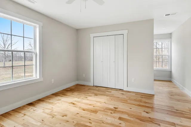 wooden floor in an empty room with a window