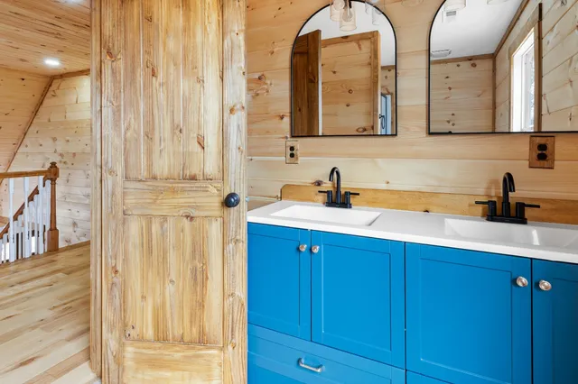 a view of empty room with a fireplace and wooden floor