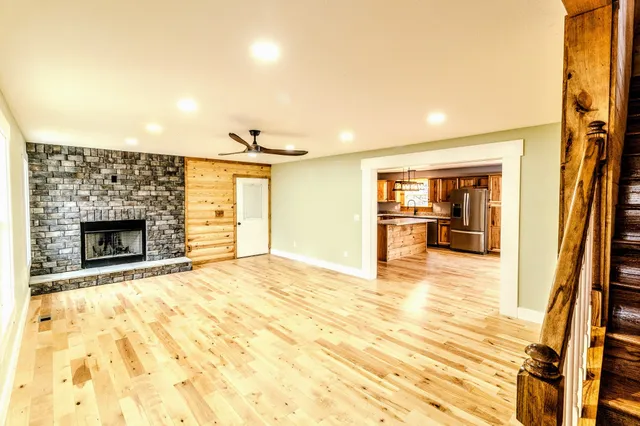 a view of an house with backyard and trees