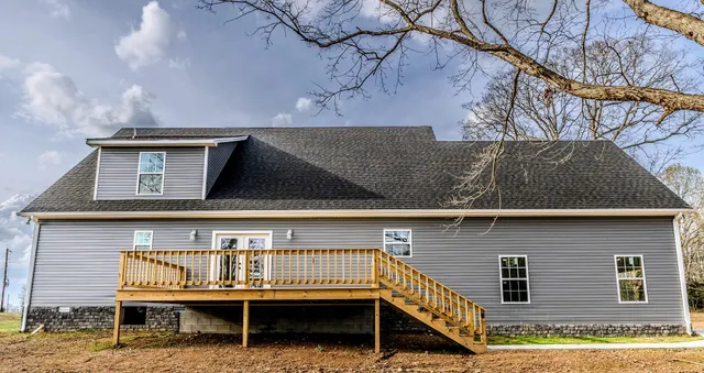 a view of staircase with a chair and table